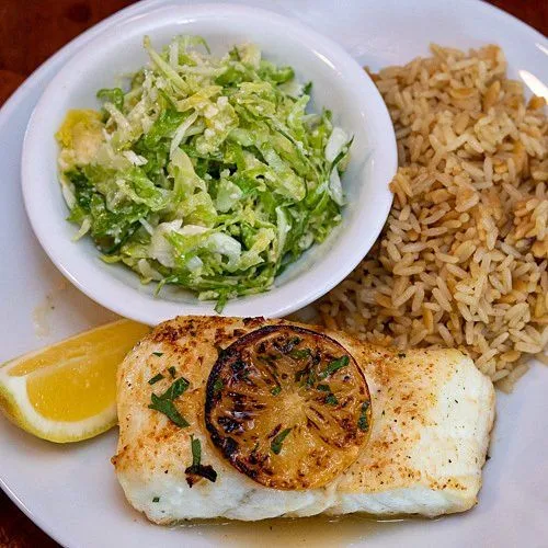 Baked fish fillet with salad and rice