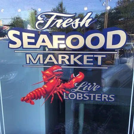 Fresh Seafood Market sign with live lobsters